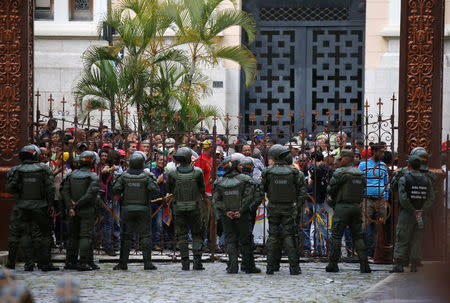 Government supporters stand outside the gates of the National Assembly as they besiege the building, preventing people on the inside from leaving, in Caracas, Venezuela July 5, 2017. REUTERS/Carlos Garcia Rawlins