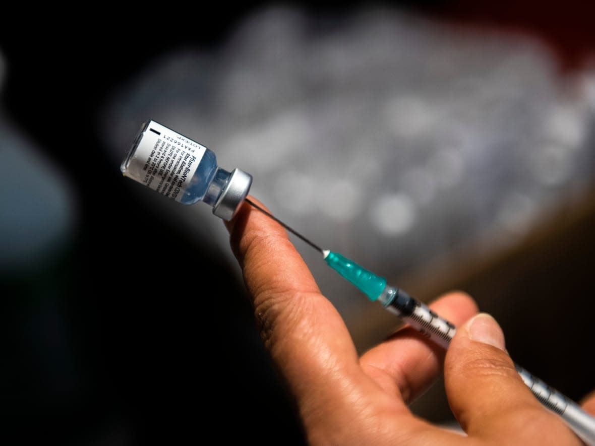 A nurse prepares a shot of the Pfizer vaccine for COVID-19 during a vaccination campaign for third doses at Antel Arena in Montevideo, Uruguay. Third doses will be available to some Nova Scotians starting next week. (Matilde Campodonico/The Associated Press - image credit)