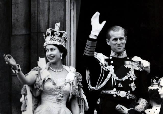 The Queen and the Duke of Edinburgh waving from the balcony of Buckingham Palace after the coronation