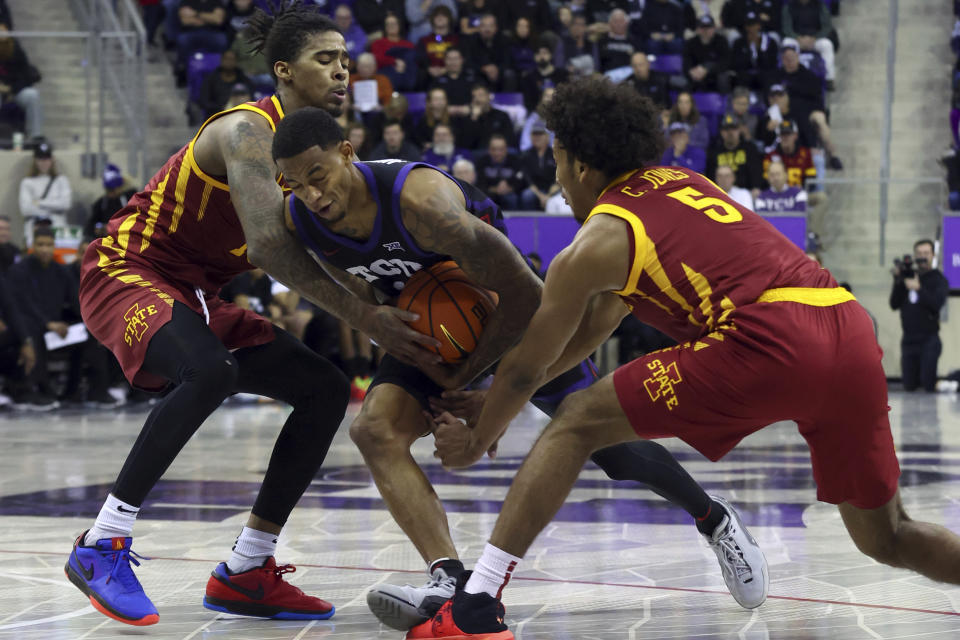 Iowa State guards Keshon Gilbert, left, and Curtis Jones (5) defend as TCU guard Avery Anderson III, center, tries to drive the ball past in the first half of an NCAA college basketball game Saturday, Jan. 20, 2024, in Fort Worth, Texas. (AP Photo/Richard W. Rodriguez)