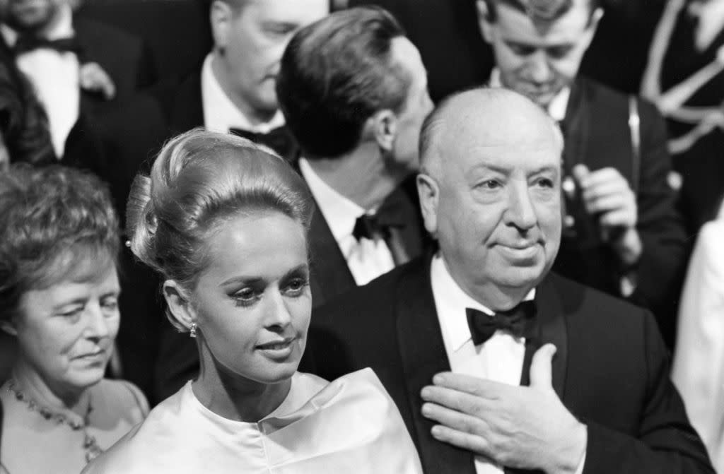 Tippi Hedren and Alfred Hitchcock attend the premiere of The Birds on May 10, 1965, at the Cannes Film Festival in France. (Photo: Gamma-Rapho via Getty Images)