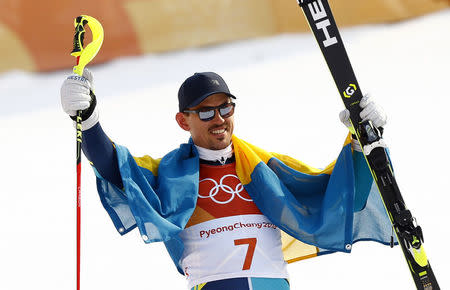 Alpine Skiing - Pyeongchang 2018 Winter Olympics - Men's Slalom - Yongpyong Alpine Centre - Pyeongchang, South Korea - February 22, 2018 - Andre Myhrer of Sweden wears a flag as he celebrates. REUTERS/Kai Pfaffenbach