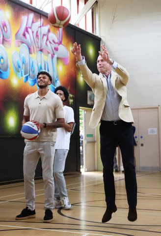 <p>Cameron Smith/Getty</p> Tyrone Mings and Prince William play basketball on June 27