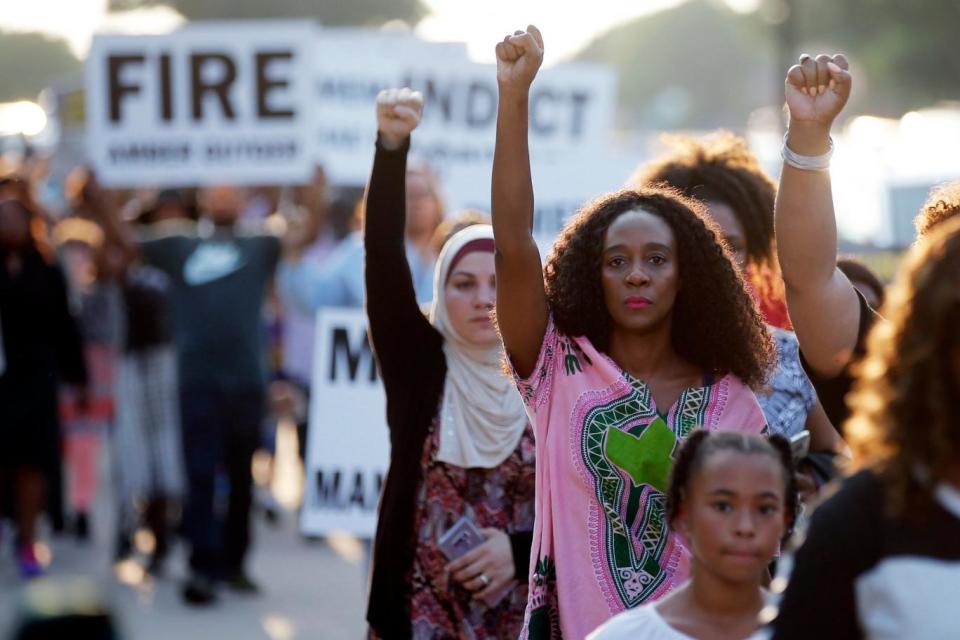 Prior to Guyger being let go, protesters marched outside an NFL football game against the killings of two black men in Arlington Texas. As well as Botham Jean, O'Shae Terry was fatally shot by police earlier this month. They called for Amber Guyger to be fired. (AP)