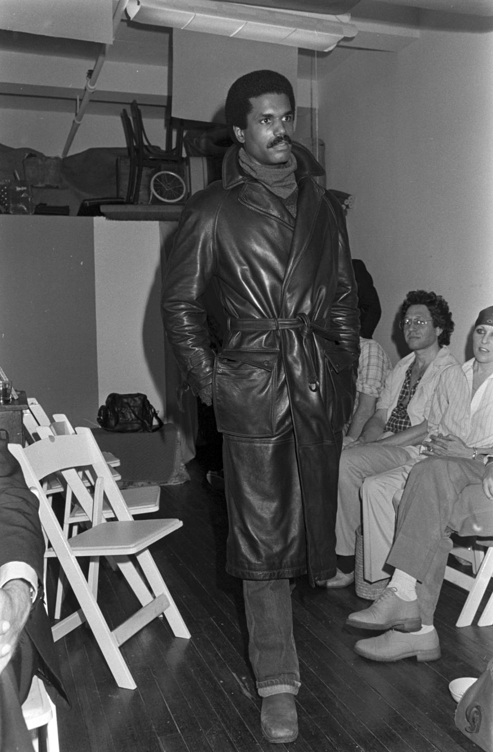 Model Renauld White poses in a leather coat during Conrad Bell's men's fall 1978 outwear collection fashion show in New York City.