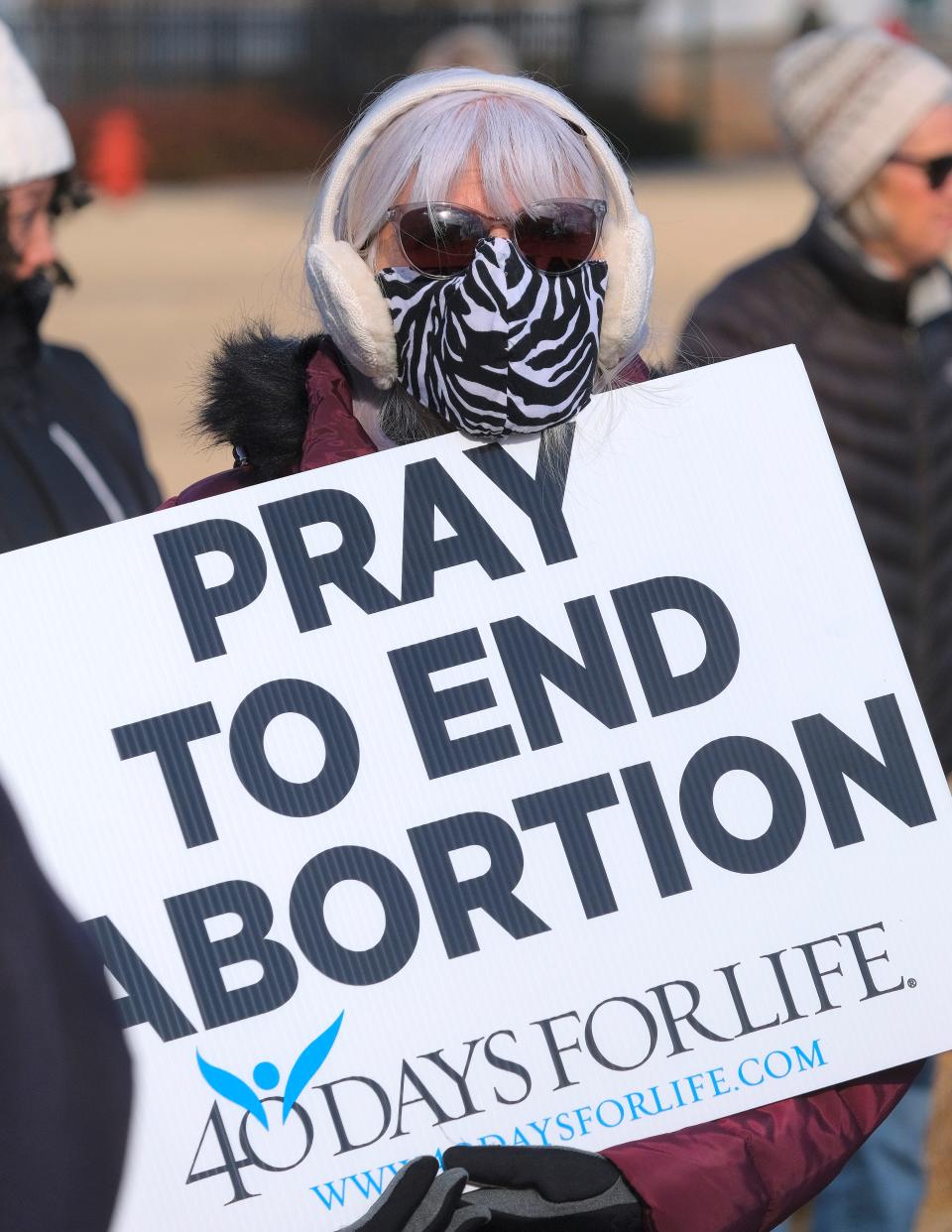 An Oklahoma March for Life participant holds up an anti-abortion sign during the anti-abortion march from the state Capitol to Midtown on Saturday in Oklahoma City.