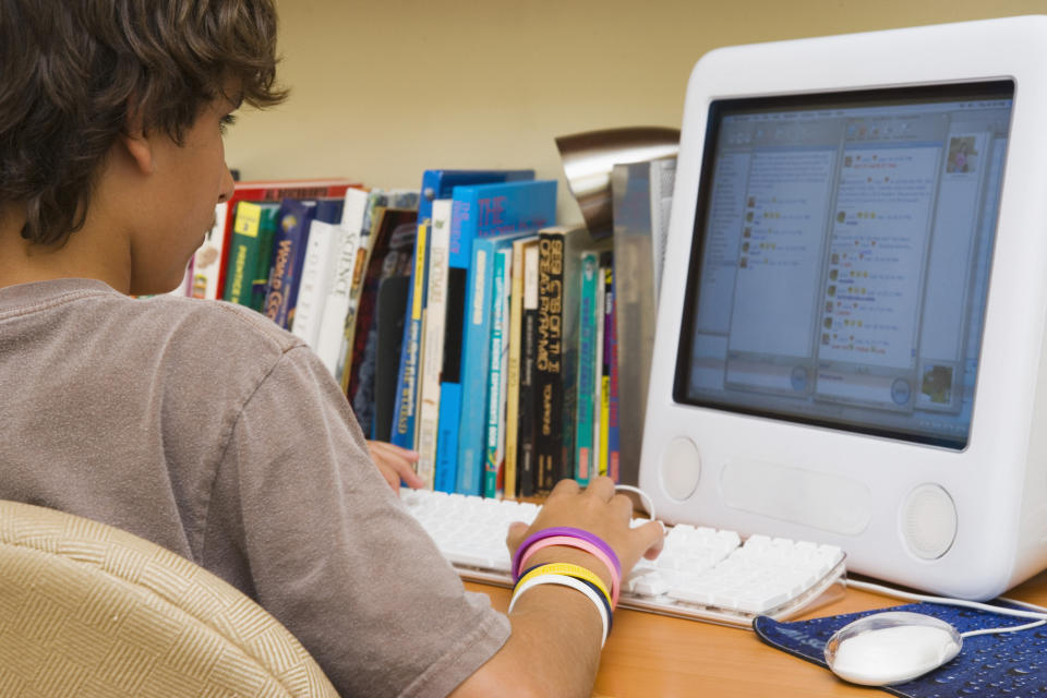 A young kid using a desktop computer