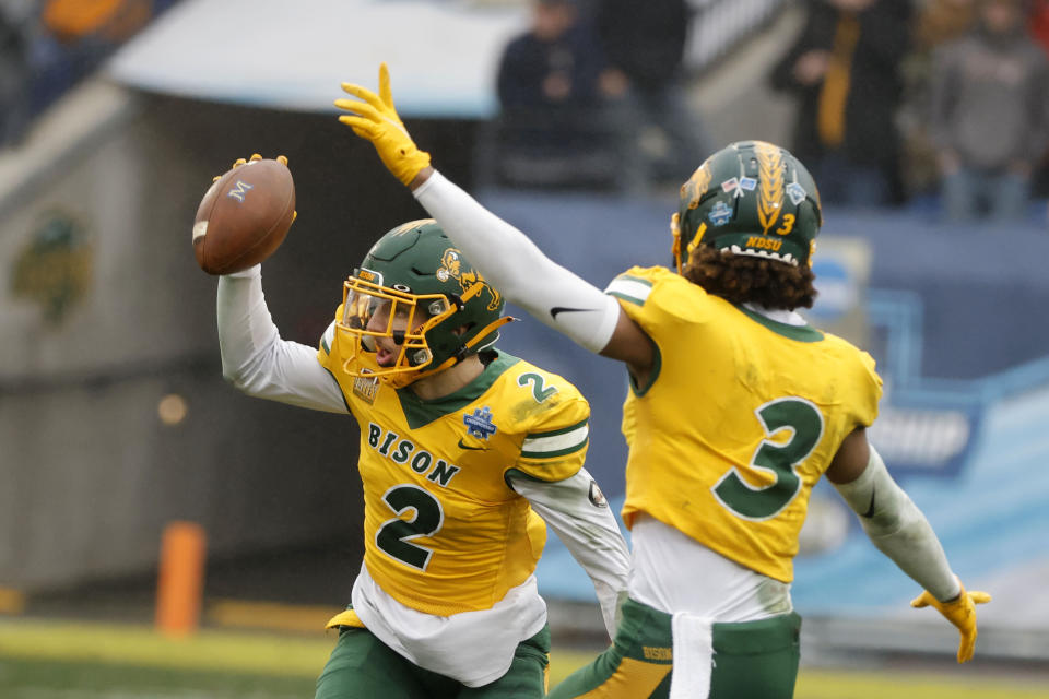 North Dakota State safety Dawson Weber (2) celebrates his interception against Montana State with teammate Jasir Cox (3) during the first half of the FCS Championship NCAA college football game in Frisco, Texas, Saturday, Jan. 8, 2022. (AP Photo/Michael Ainsworth)