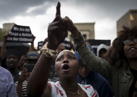 Residents, who marched from west Baltimore to City Hall, react to protest leaders who were chronicling the arrest and death of Freddie Gray, in Baltimore, Maryland April 30, 2015. REUTERS/Adrees Latif