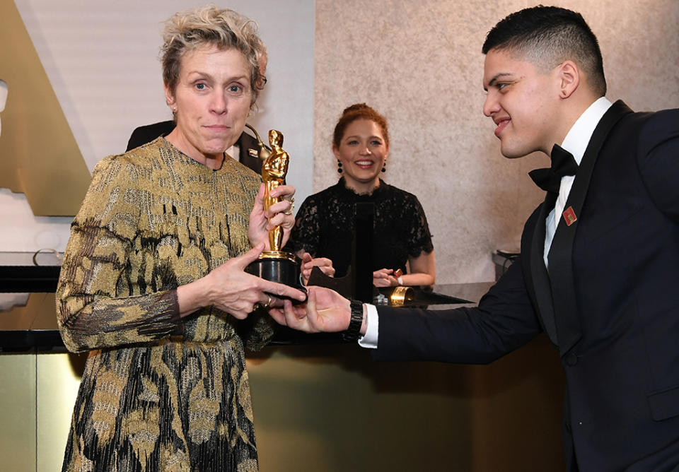 <p>The Best Actress winner got a helping hand from proud son Pedro McDormand Coen. (Photo: Angela Weiss/AFP/Getty Images) </p>