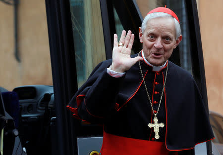 Cardinal Donald William Wuerl from U.S. waves as he arrives for a meeting at the Synod Hall in the Vatican March 7, 2013. REUTERS/Alessandro Bianchi/Files