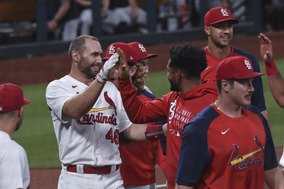 St. Louis Cardinals' Paul Goldschmidt, left, is congratulated by teammates after hitting a home run during the ninth inning of the team's baseball game against the Miami Marlins on Tuesday, June 15, 2021, in St. Louis. (AP Photo/Joe Puetz)