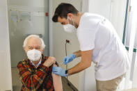 FILE - Kurt Switil, left, receives a Pfizer vaccination against the coronavirus in Vienna, April 10, 2021. Austria's parliament is due to vote Thursday, Jan. 20, 2022, on plans to introduce a COVID-19 vaccine mandate for the adult population, the first of its kind in Europe. (AP Photo/Lisa Leutner, File)