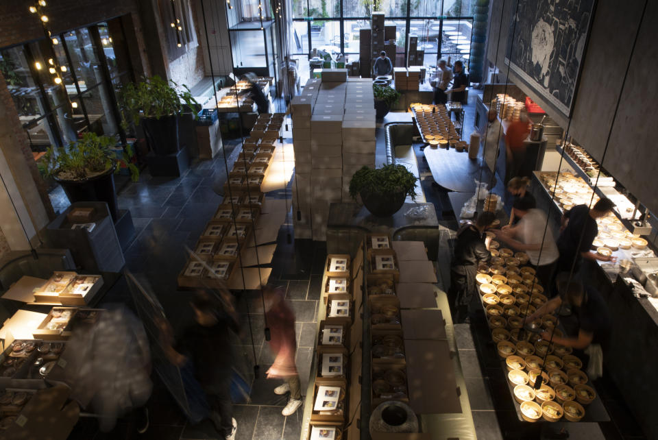 Staff prepare part of nearly 600 take-away orders at Sergio Herman's Le Pristine restaurant in Antwerp, Belgium, Saturday, Nov. 7, 2020. Of all the many challenges the pandemic throws up for all kinds of professions, this one has been particularly tough: How to put a three-star chef into a takeout box. (AP Photo/Virginia Mayo)