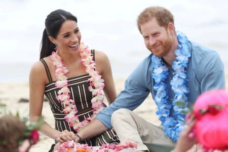 Britain's Prince Harry and his wife Meghan, Duchess of Sussex, meet participants of Fluro Friday, an event organized by surfing community OneWave tackling mental health issues, during their visit to Bondi Beach in Sydney, Australia October 19, 2018. Chris Jackson/Pool via REUTERS