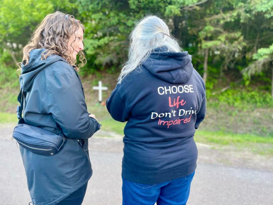 Karen Clinton of Mothers Against Drunk Driving consoles Trish Vanderweerd at the vigil Friday night. Vanderweerd is wearing a sweater emblazoned with the message Choose Life, Don't Drive Impaired.