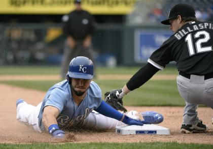 Eric Hosmer slides into third for a steal past the tag of Conor Gillaspie in the eighth inning Thursday. (Getty)