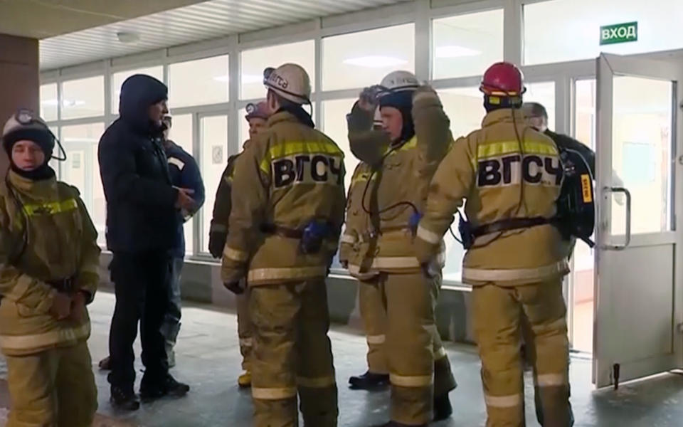 In this video grab provided by RU-RTR Russian television, a Russian rescue team prepares to go down into the potash mine in Solikamsk, the Perm region near the Ural Mountains, Russia, Sunday, Dec. 23, 2018. Rescue teams in Russia's Ural Mountains are still looking for a construction worker trapped inside a burning potash mine after the bodies of eight of his colleagues were found. (RU-RTR Russian Television via AP)