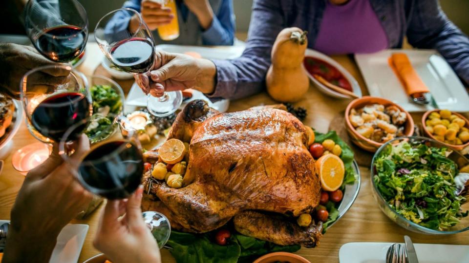 PHOTO: This stock photo depicts a family toasting with a glass of wine before enjoying a Thanksgiving meal. (STOCK/Getty Images)