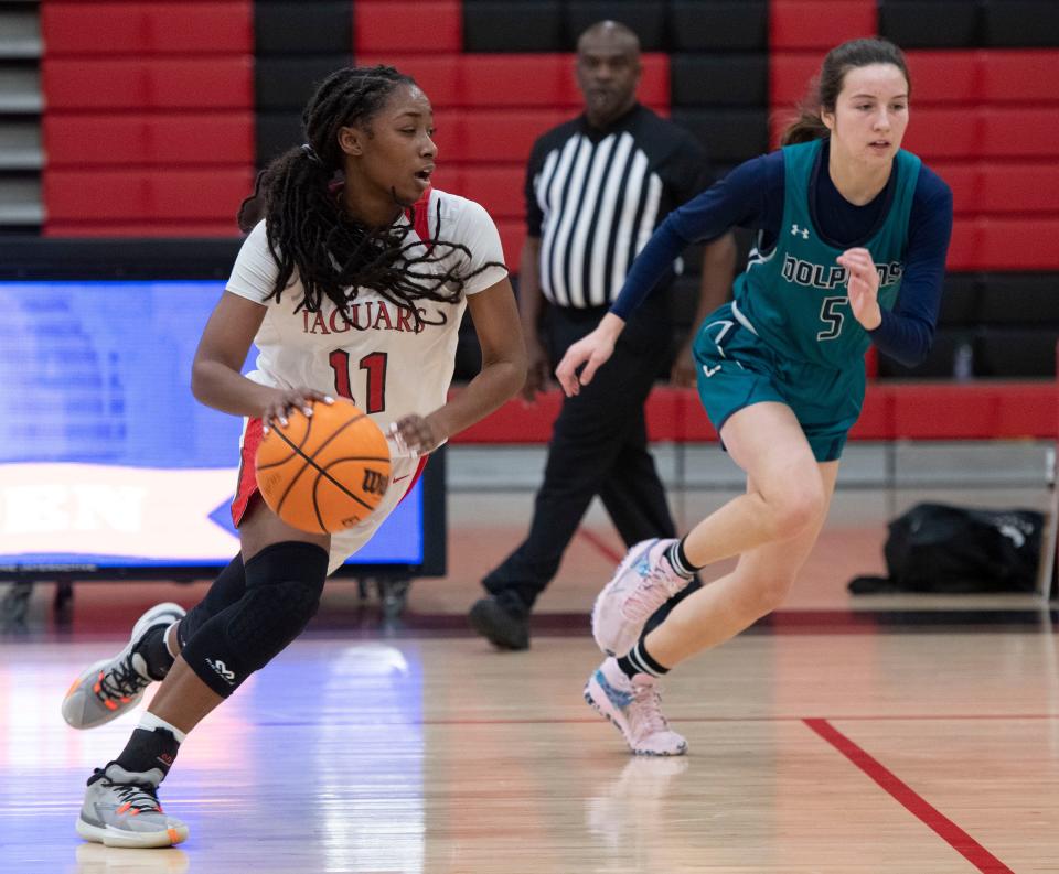 West Florida's Amari Franklin (No. 11) drives past Gulf Shores Baylee Taylor (No. 5) during the Gulf Coast MLK Dream Keeper Showcase at West Florida on Monday, Jan. 17, 2022.