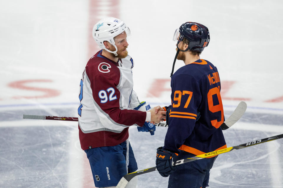 Colorado Avalanche's Gabriel Landeskog (92) and Edmonton Oilers' Connor McDavid (97) shake hands after the Avalanche beat the Oilers in overtime NHL playoff hockey action in Edmonton, Alberta, Monday, June 6, 2022. The Avalanche won the game 6-5, to take the series. (Amber Bracken/The Canadian Press via AP)