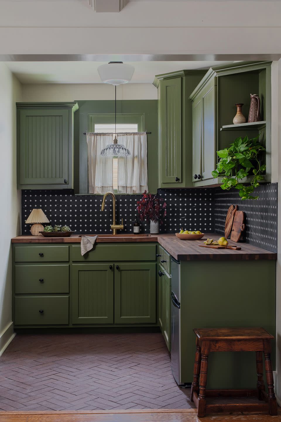 a kitchen with green cabinets