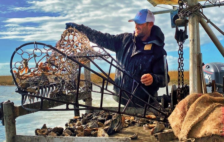 Jacob Hulse harvests oysters on his brother Jason’s boat.