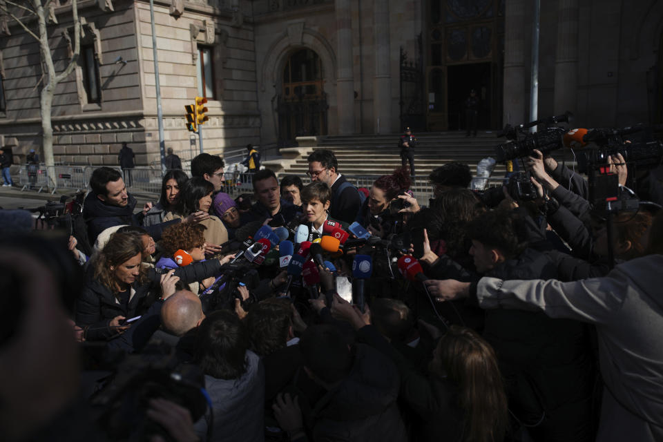 Soccer star Dani Alves' lawyer Ines Guardiola, centre, speaks as she is surrounded by media outside the court in Barcelona, Spain, Thursday, Feb. 22, 2024. Dani Alves has been found guilty of sexually assaulting a young woman in a Barcelona nightclub. A three-judge panel in a Barcelona court sentenced Alves to four years, six months. The 40-year-old Alves denied any wrongdoing during a trial that took place over three days this month. The decision can be appealed. (AP Photo/Emilio Morenatti)