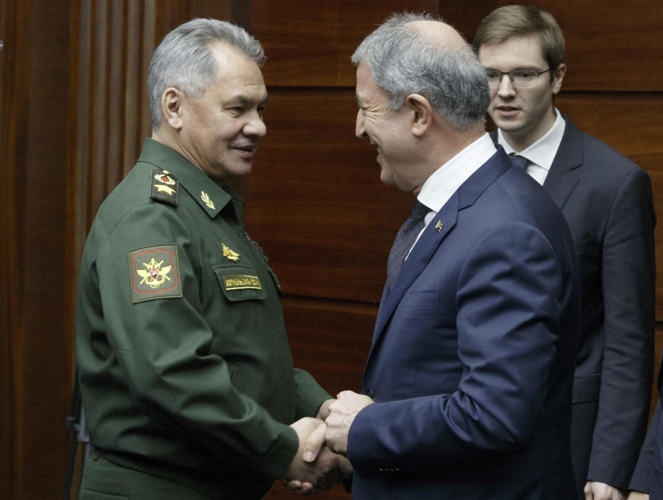 Russian Defense Minister Sergei Shoigu, left, and Turkey's Defense Minister Hulusi Akar shake hands during their meeting in Moscow, Russia, Saturday, Dec. 29, 2018. (Vadim Savitsky, Russian Defense Ministry Press Service via AP)