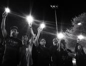 <p>Attendees at a memorial service wave their iPhones with the flashlight activated in honor of the victims of Sunday’s massacre in Sutherland Springs, Texas. (Photo: Holly Bailey/Yahoo News) </p>