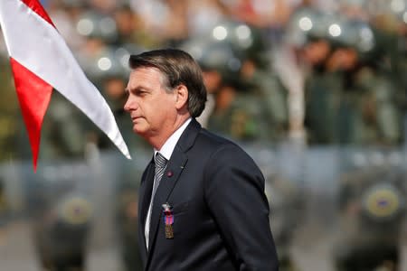 FILE PHOTO: Brazil's President Jair Bolsonaro looks on during a Soldier's Day ceremony, in Brasilia