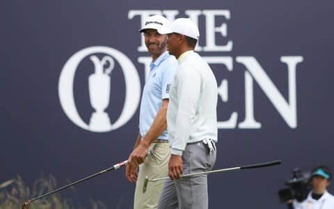 Dustin Johnson of the United States talks to Tiger Woods of the United States during a practice round prior to the 148th Open Championship held on the Dunluce Links at Royal Portrush Golf Club - Credit: GETTY IMAGES