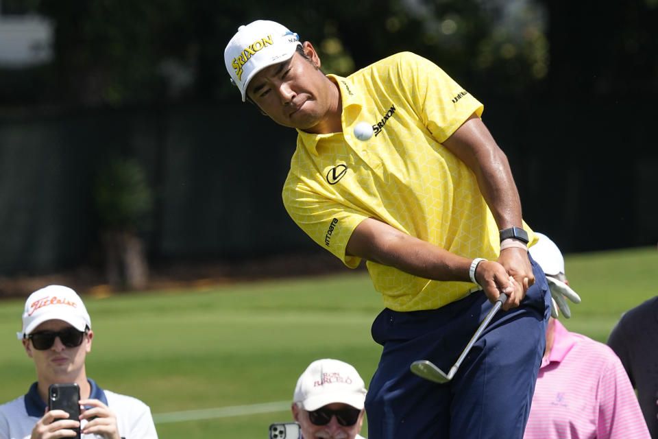 Hideki Matsuyama, of Japan, chips to the first green during the final round of the Tour Championship golf tournament at East Lake Golf Club, Sunday, Aug. 28, 2022, in Atlanta. (AP Photo/Steve Helber)