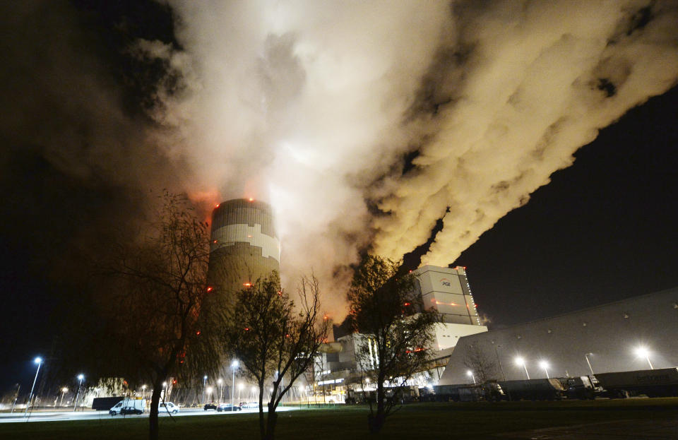 FILE - In this Wednesday Nov. 28, 2018 file photo, clouds of smoke over Europe's largest lignite power plant in Betchatow, central Poland. Energy experts were working to restore full operations at Poland’s biggest power plant, the lignite-fueled Belchatow, after an energy network failure switched off 10 of the plant’s 11 units. Poland needed energy imports from Germany, Sweden, the Czech Republic and Slovakia to fill in for the suddenly missing power. (AP Photo/Czarek Sokolowski, File)