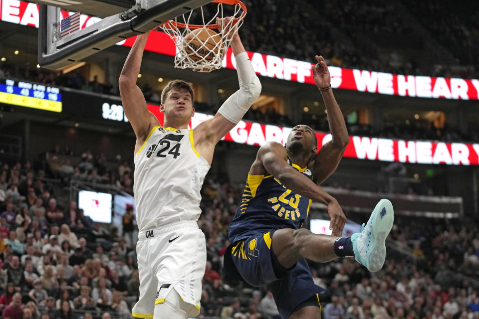 Utah Jazz center Walker Kessler (24) dunks against Indiana Pacers forward Aaron Nesmith (23) during the second half of an NBA basketball game Friday, Dec. 2, 2022, in Salt Lake City. (AP Photo/Rick Bowmer)