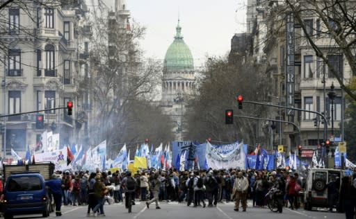 Demonstrators, backdropped by the Congress building, block the 9 de Julio avenue in Buenos Aires, where they gathered to protest against the government of Argentine President Mauricio Macrion September 12, 2018
