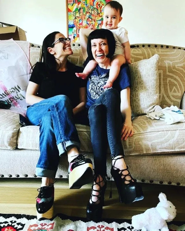 Fatma Marouf (left), Bryn Esplin (right), and their daughter at home in Fort Worth, Texas.