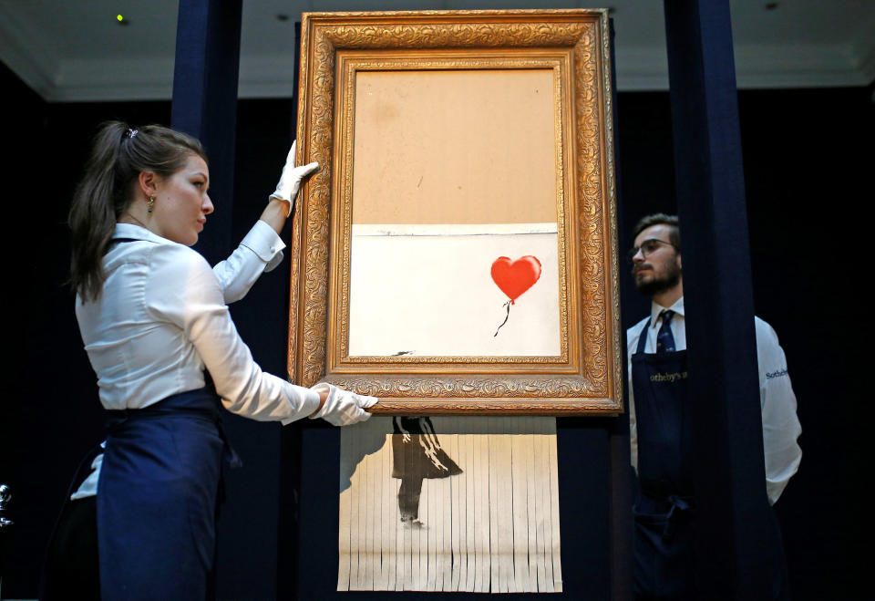 Banksy's Love Is In The Bin artwork shredded at Sotheby's auction in London.