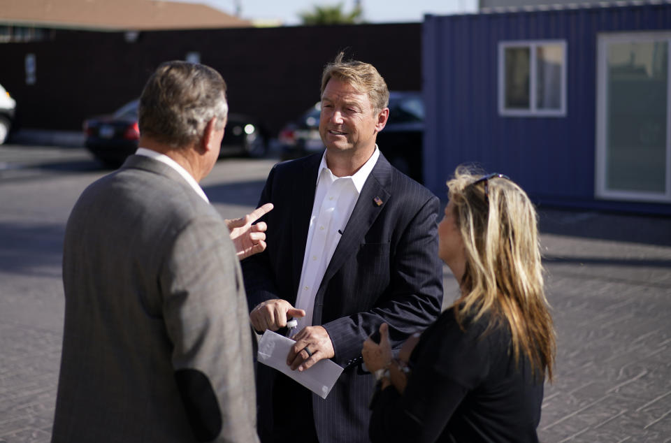 Former U.S. Sen. Dean Heller, center, tours Share Village Las Vegas after announcing a bid for governor of Nevada, Monday, Sept. 20, 2021, in Las Vegas. (AP Photo/John Locher)