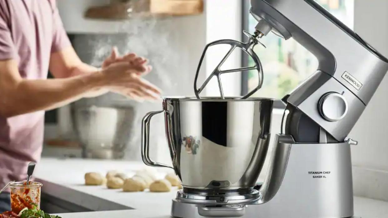  Kenwood Chef XL Titanium Stand Mixer on a countertop with dough in the background 