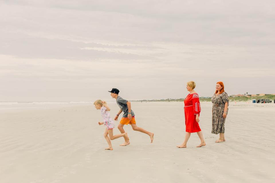 Sisters Inna Novak and Liudmyla Rybak, along with their children, relax on a beach in Florida where they are being sponsored by the Uniting for Ukraine program for refugees.