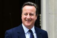 British Prime Minister David Cameron reacts as he departs 10 Downing Street enroute to the Houses of Parliament in central London on June 27, 2016