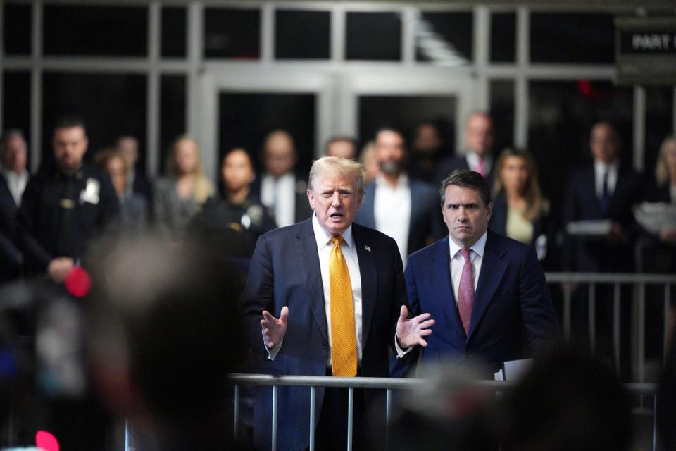 Former President Donald Trump, with his attorney Todd Blanche at his side, speaks to reporters on Wednesday (AP)