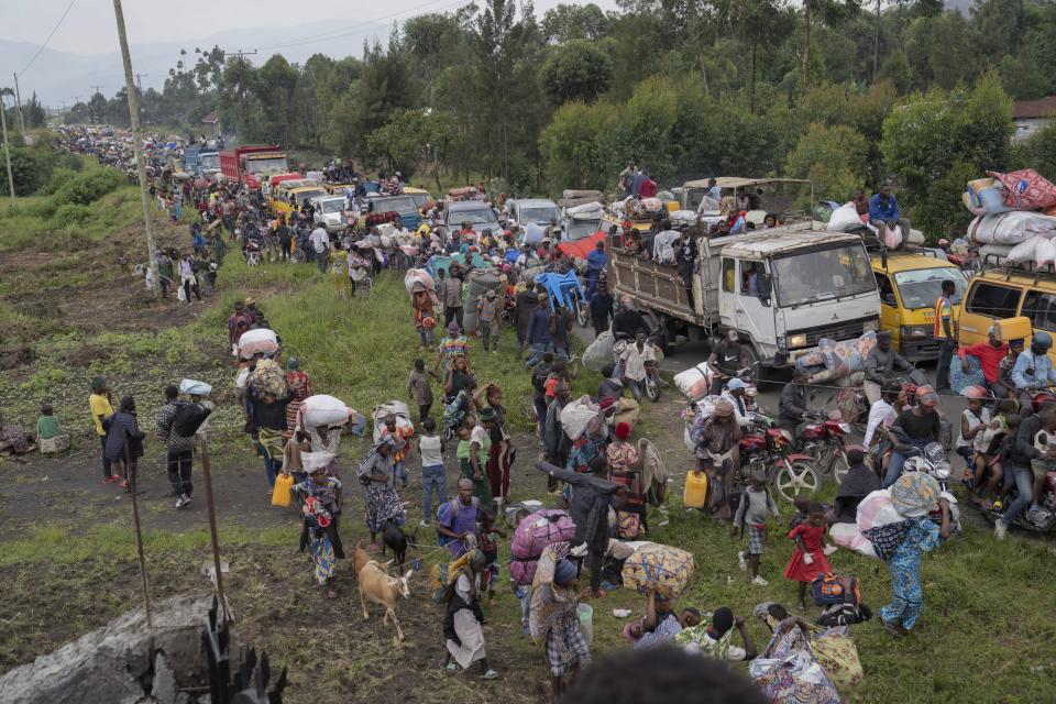 Thousands who are fleeing the ongoing conflict between government forces and M-23 rebels reach the entrance the Democratic Republic of Congo eastern city of Goma Wednesday, Feb. 7, 2024. (AP Photo/Moses Sawasawa)