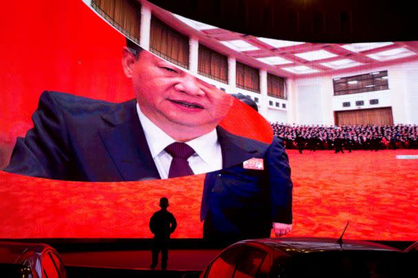 PHOTO: A child stands near a large screen showing photos of Chinese President Xi Jinping near a car park in Kashgar in western China's Xinjiang region on Dec. 3, 2018. (AP Photo/Ng Han Guan, File)