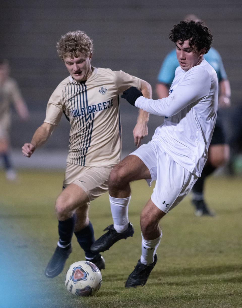 Colin Troxell (6) and Evan McManus (9) fight for the ball during the Booker T. Washington vs Gulf Breeze boys soccer game at Gulf Breeze High School on Thursday, Jan. 11, 2024.