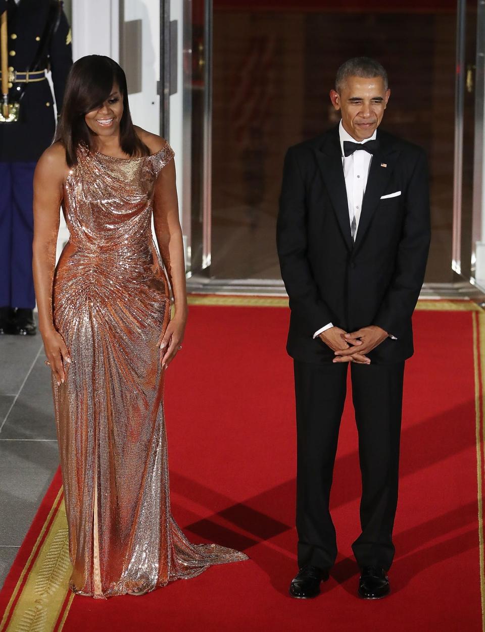 Michelle Obama wears a metallic Versache gown to a state dinner ini 2016.