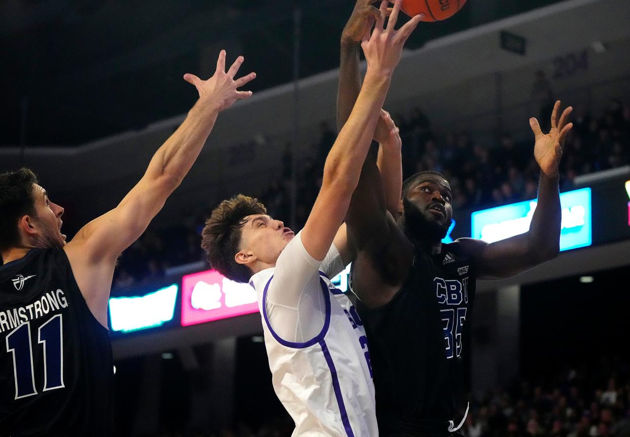 December 29, 2022; Phoenix, Ariz; USA; GCU forward Isaiah Carr (23) goes up for a basket against CBU center Tim Ighoefe (35) during a game at Grand Canyon University. 