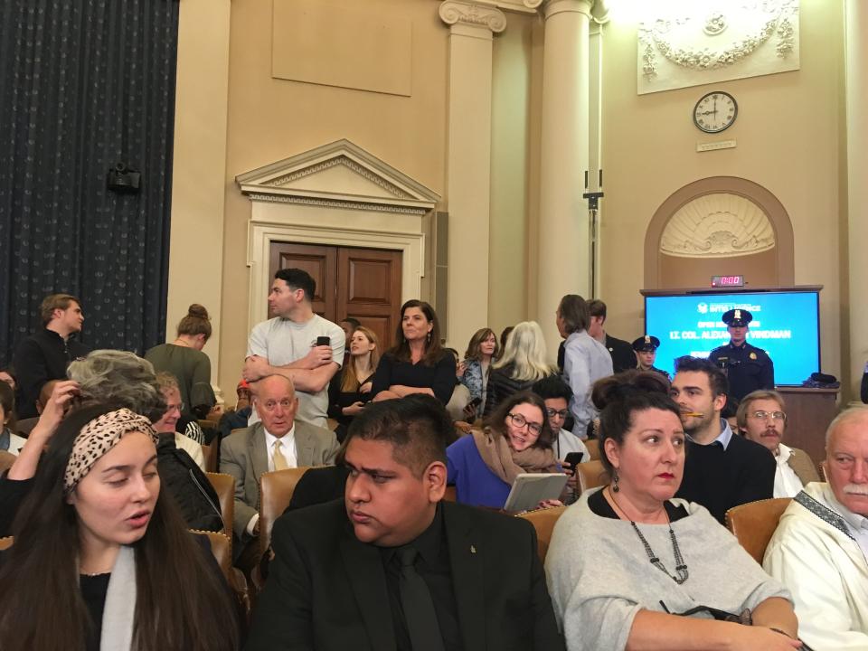 USA TODAY editor-in-chief Nicole Carroll (standing) surveys the scene inside the House hearing room Tuesday, where Lt. Col. Alexander Vindman was about to testify in the impeachment inquiry of President Trump.