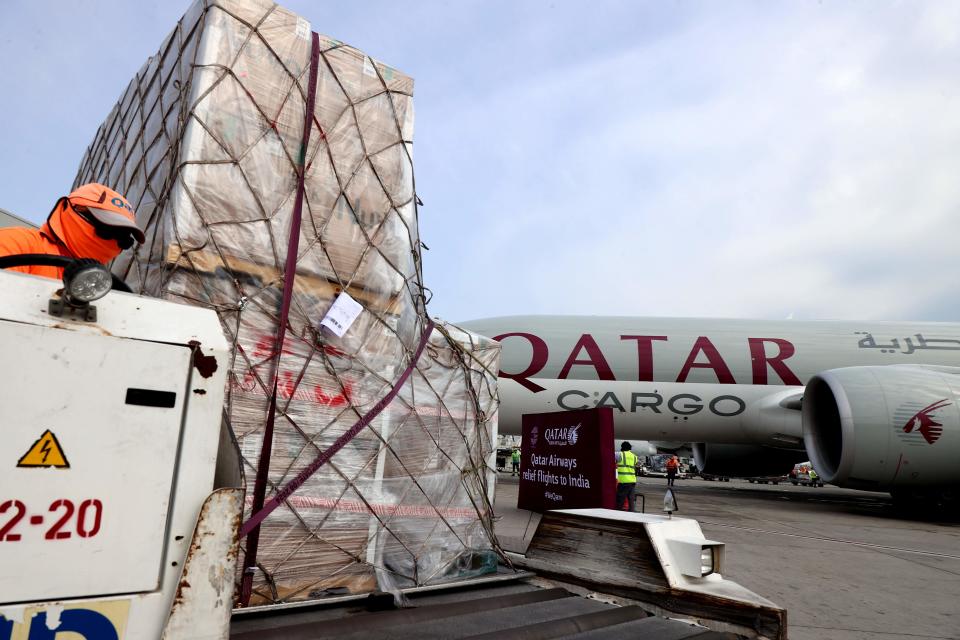 <p>Workers load 300 tonnes of medical aid to be flown in a three-flight cargo aircraft convoy directly to destinations in India</p> (AFP via Getty Images)